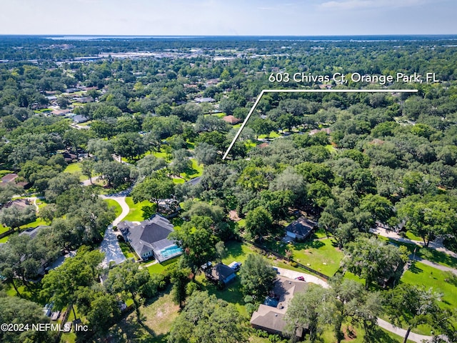 birds eye view of property with a view of trees