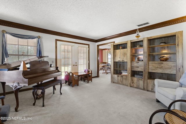 living area featuring french doors, light colored carpet, visible vents, ornamental molding, and a textured ceiling