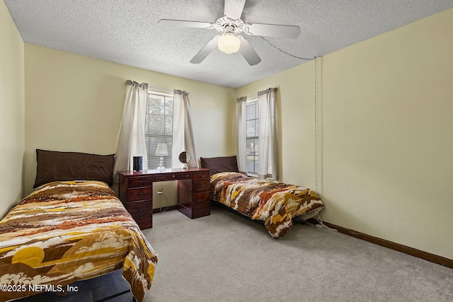 bedroom featuring light carpet, a ceiling fan, baseboards, and a textured ceiling