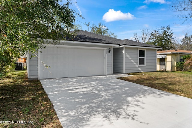 single story home with a garage, concrete driveway, and a front lawn