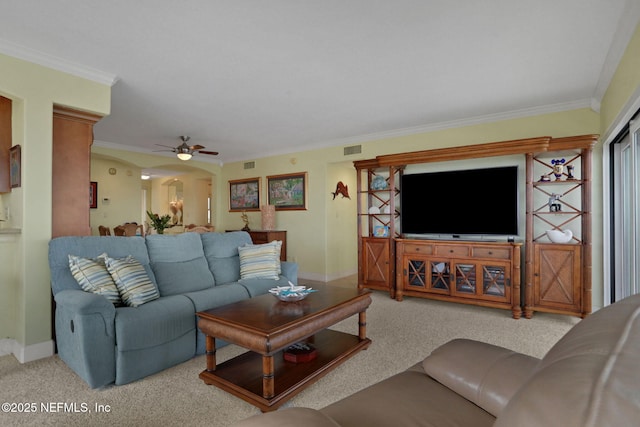 carpeted living room featuring ceiling fan, ornamental molding, visible vents, and baseboards