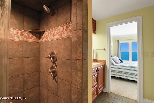 ensuite bathroom featuring a water view, a tile shower, vanity, ensuite bath, and tile patterned flooring