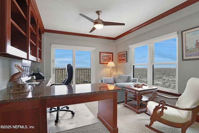 office area featuring ornamental molding, light carpet, and a ceiling fan