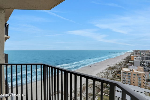 balcony featuring a water view and a beach view