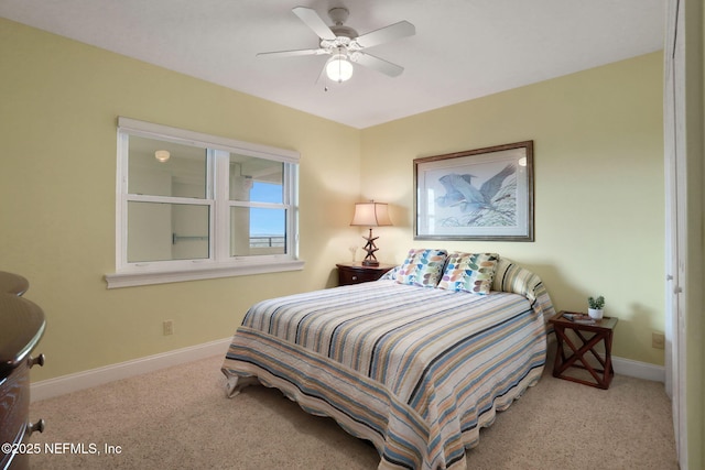 bedroom with light carpet, a ceiling fan, and baseboards