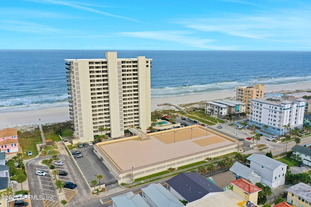 aerial view with a water view and a beach view