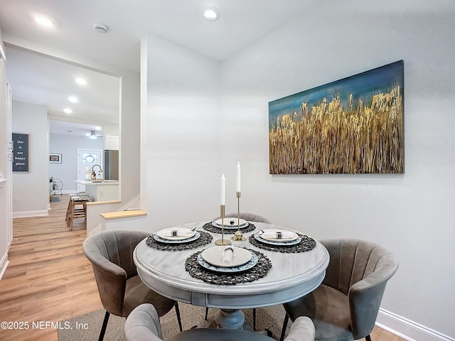 dining room with recessed lighting, light wood-type flooring, and baseboards