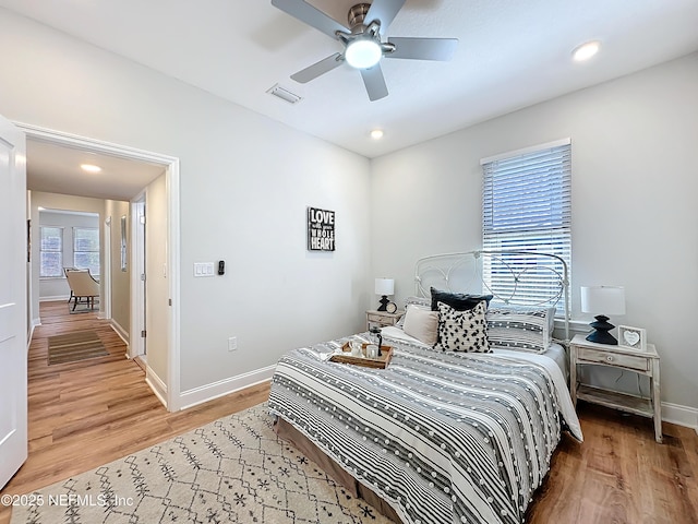 bedroom with baseboards, visible vents, a ceiling fan, wood finished floors, and recessed lighting