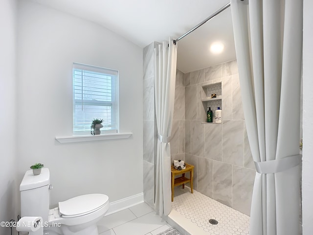 bathroom featuring tile patterned flooring, a shower stall, toilet, and baseboards