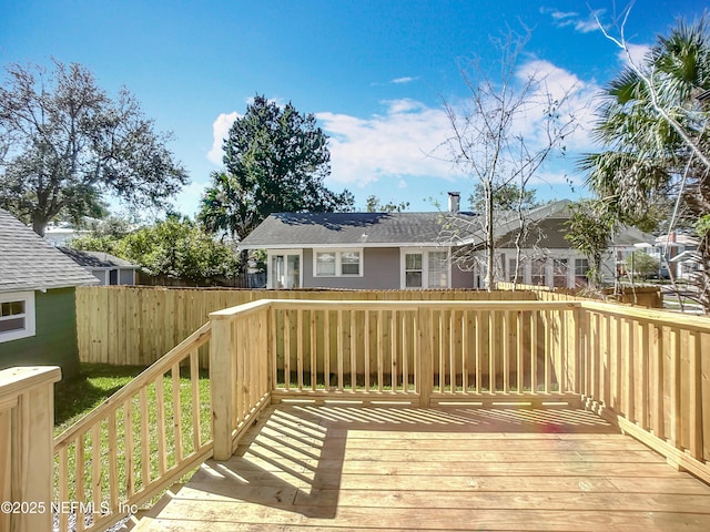 wooden terrace featuring fence