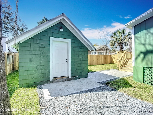 view of outdoor structure with a fenced backyard and an outdoor structure