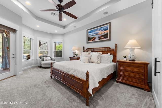 bedroom featuring baseboards, a tray ceiling, recessed lighting, access to outside, and light colored carpet