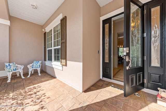 entrance to property with stucco siding