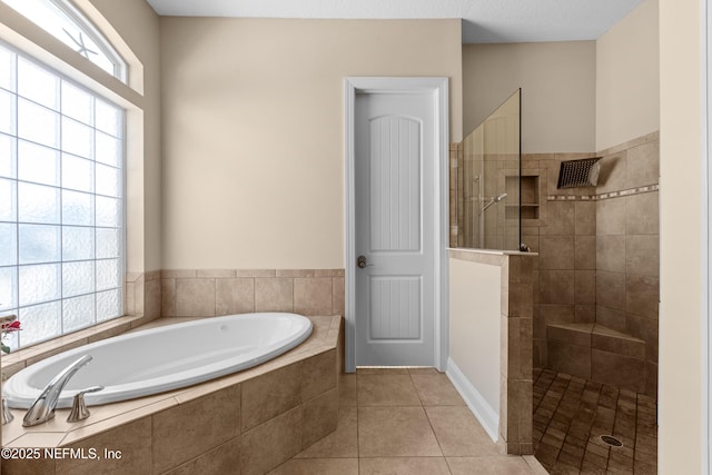 full bath with tile patterned flooring, a garden tub, and walk in shower