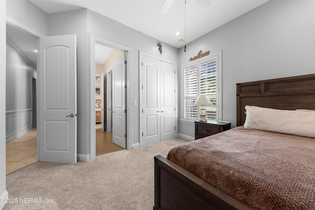 carpeted bedroom featuring a closet and ceiling fan