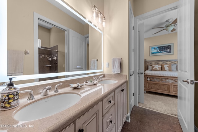 full bathroom with tile patterned floors, double vanity, tiled shower, and a sink