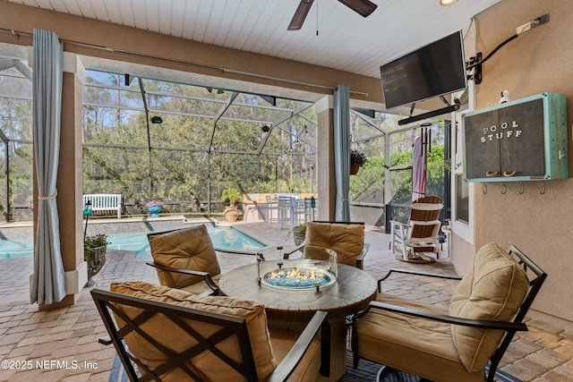 sunroom / solarium featuring a healthy amount of sunlight and ceiling fan