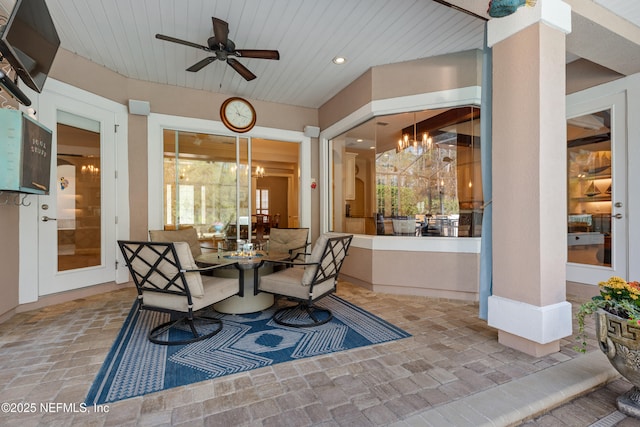 exterior space with outdoor dining space and a ceiling fan