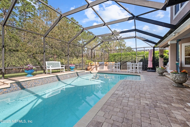 outdoor pool with a patio and area for grilling