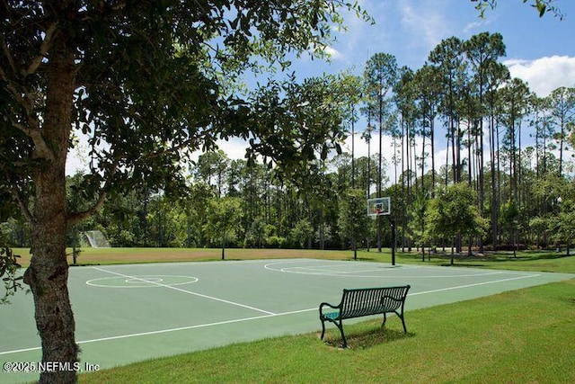 view of sport court featuring a lawn and community basketball court