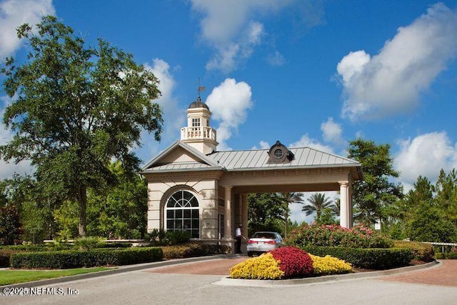 view of property featuring an attached carport and driveway