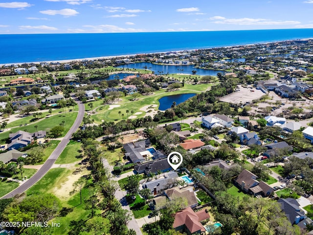 drone / aerial view featuring a residential view, a water view, and view of golf course