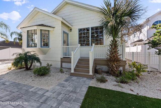 view of front of property featuring fence