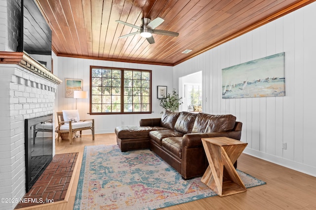 living room with wood finished floors, wood ceiling, and a wealth of natural light