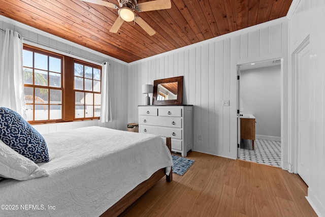 bedroom with a ceiling fan, wood ceiling, light wood-type flooring, and ornamental molding