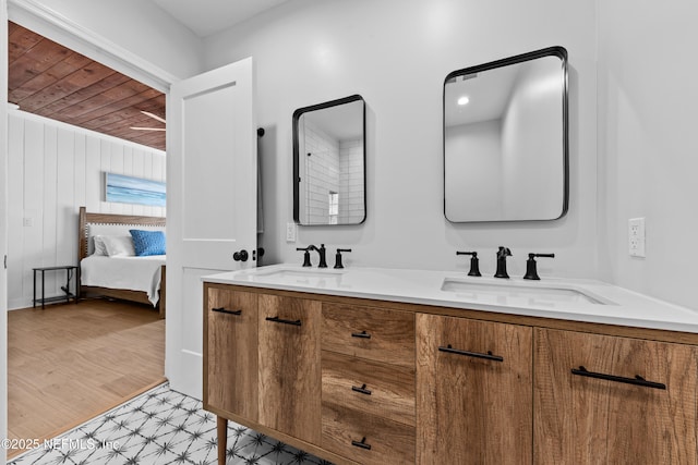 ensuite bathroom featuring a sink, ensuite bathroom, and double vanity