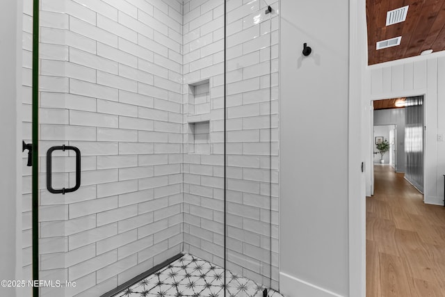 bathroom featuring a shower stall and visible vents