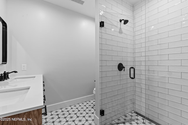 full bathroom featuring a sink, baseboards, toilet, and a stall shower