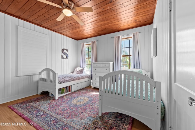 bedroom with wood ceiling, wood finished floors, and a ceiling fan