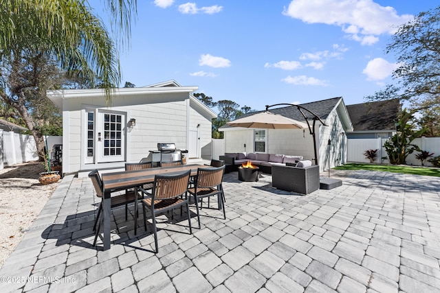 view of patio featuring a fenced backyard, an outdoor hangout area, a grill, and outdoor dining space