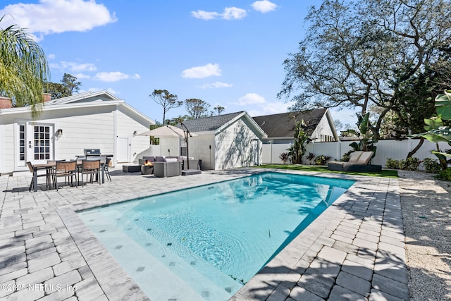 view of swimming pool with outdoor lounge area, a patio area, a fenced in pool, and a fenced backyard