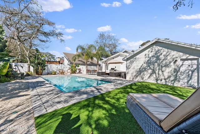 view of swimming pool featuring a fenced backyard, a yard, an outdoor hangout area, and a patio