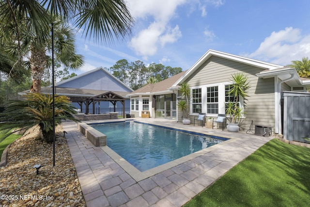 pool featuring a gazebo, a patio, and fence