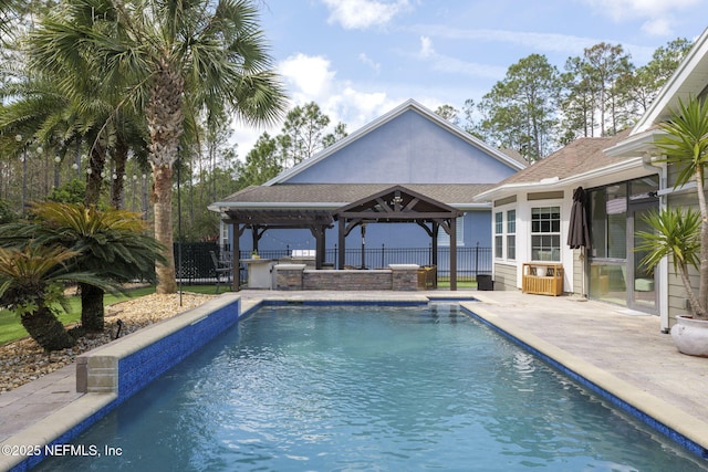 view of pool featuring a gazebo, area for grilling, fence, and a fenced in pool