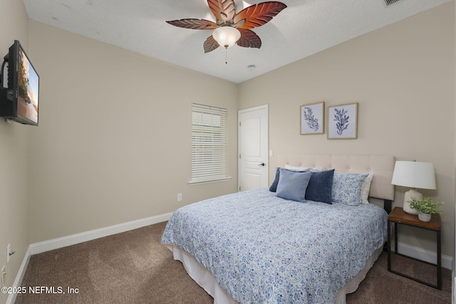 bedroom with a ceiling fan, a textured ceiling, baseboards, and carpet flooring