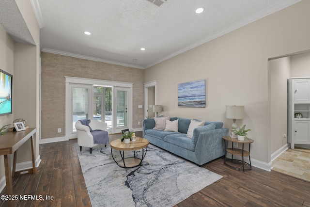 living room with baseboards, hardwood / wood-style floors, a textured ceiling, and crown molding