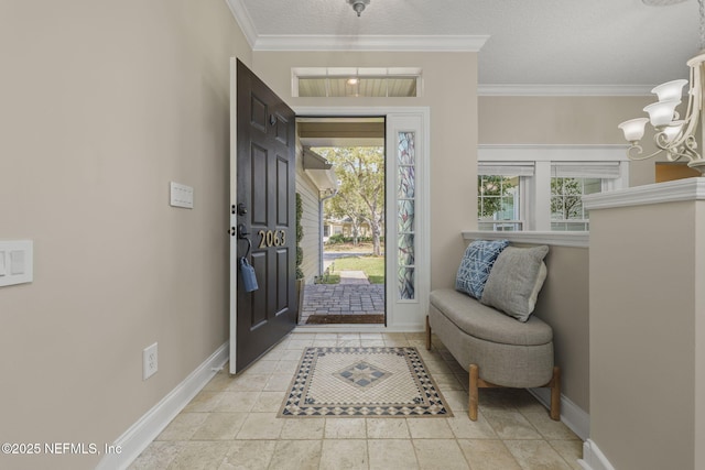 entryway featuring a notable chandelier, a textured ceiling, baseboards, and crown molding