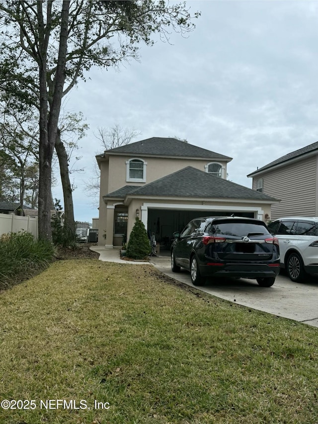 view of front of property with a garage, a front yard, concrete driveway, and fence