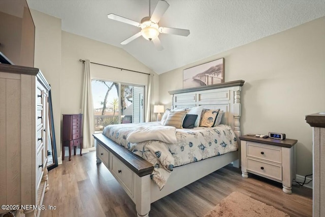 bedroom featuring vaulted ceiling, a textured ceiling, wood finished floors, and access to exterior