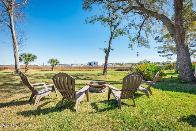 view of yard with a fire pit