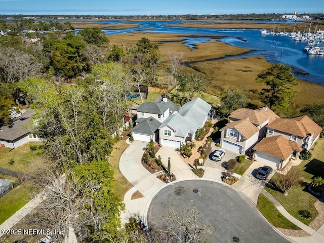 drone / aerial view with a residential view and a water view