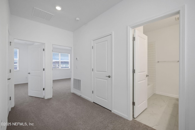 corridor with marble finish floor, recessed lighting, visible vents, and baseboards