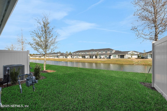 view of yard with a water view, a residential view, and cooling unit