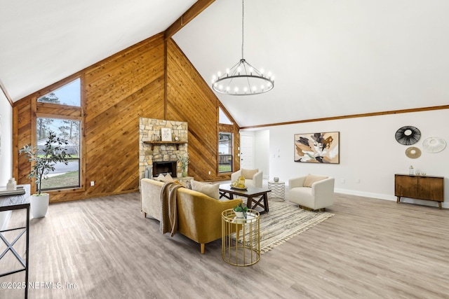 living room with high vaulted ceiling, wood walls, a fireplace, and wood finished floors