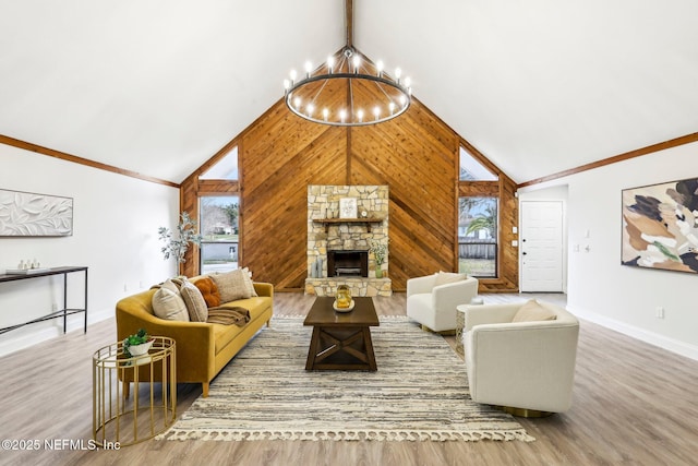 living room with wood finished floors, an inviting chandelier, a stone fireplace, wood walls, and high vaulted ceiling