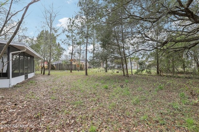 view of yard with a sunroom